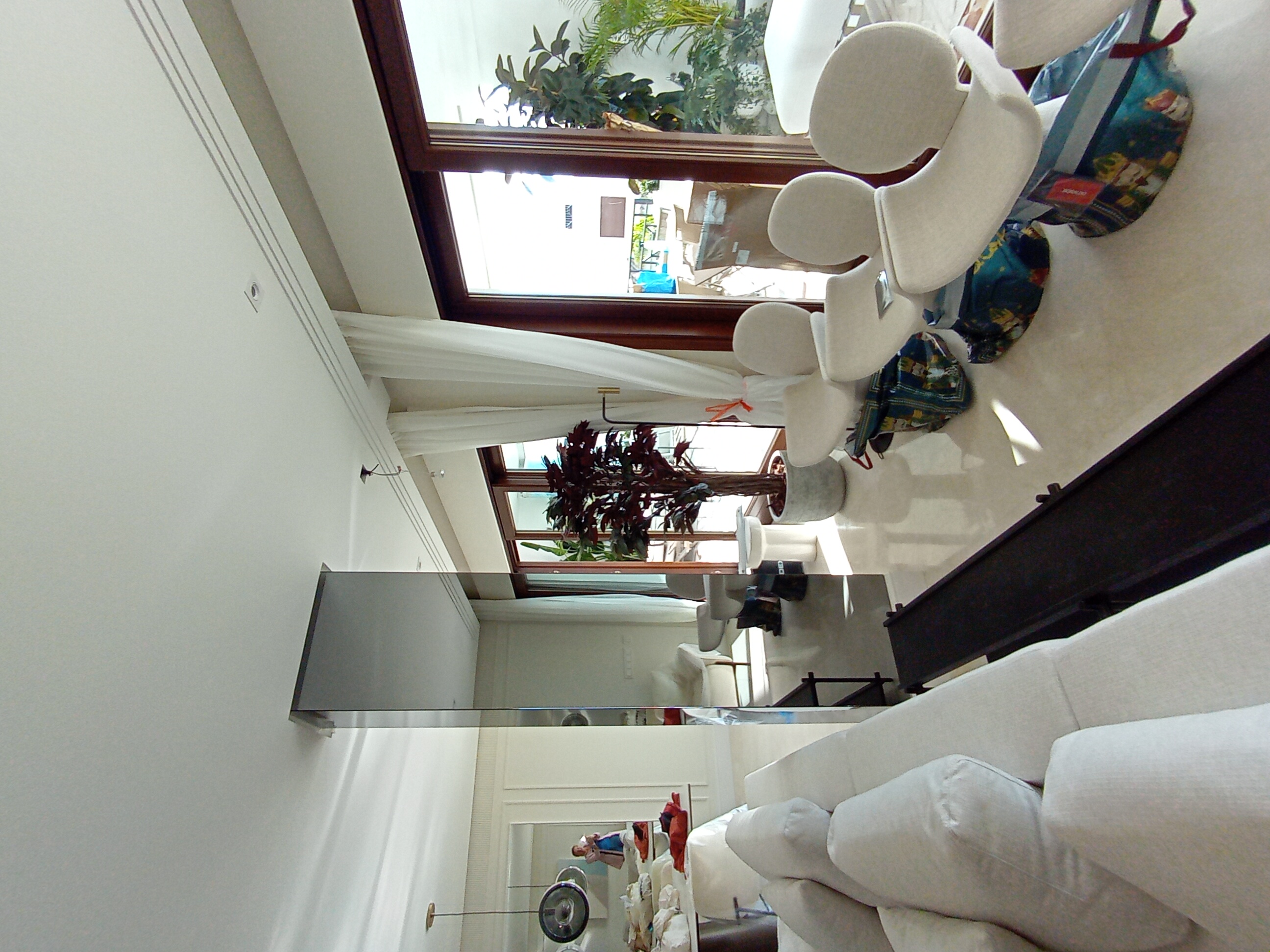 Przestronny salon z wysokim sufitem i dużymi oknami